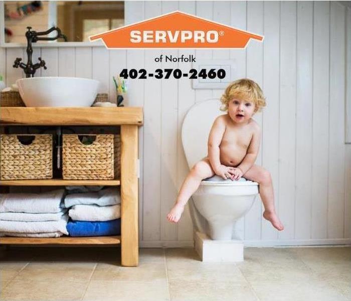 small child sitting on a toilet 